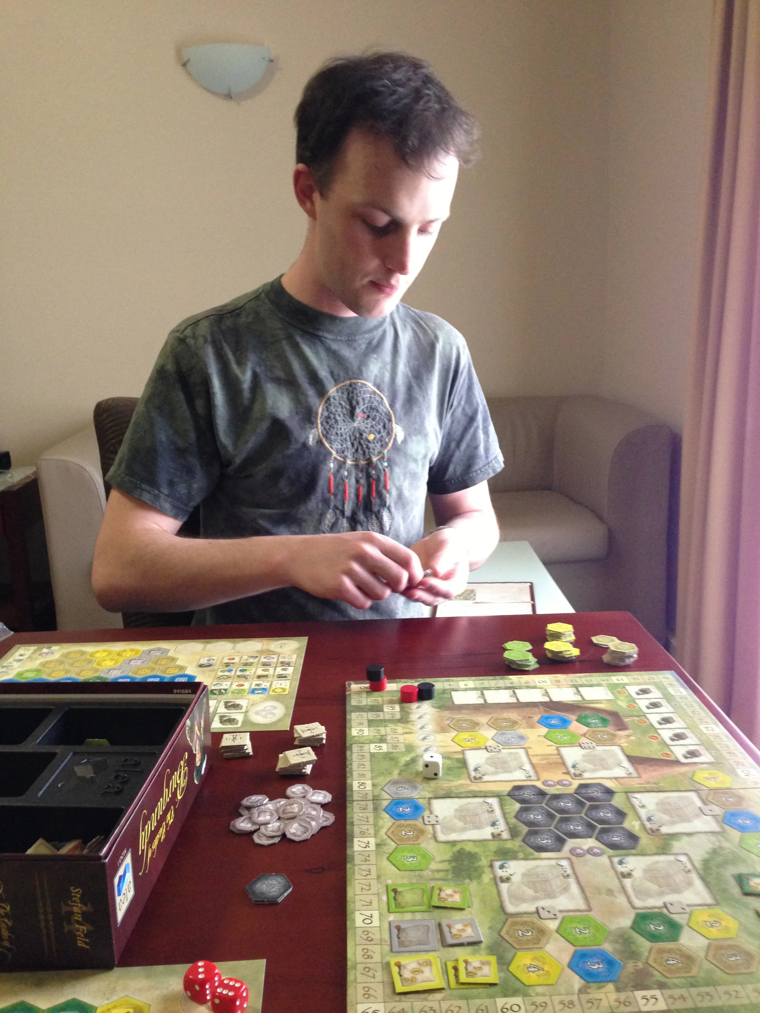 Image of Simon playing a board game.
